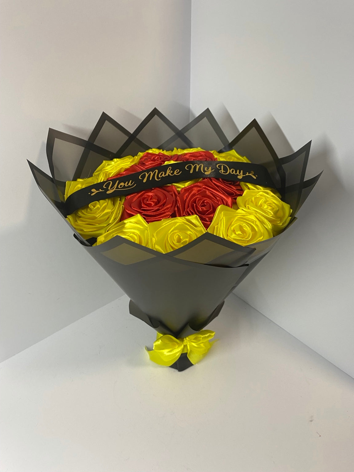 Back to School red and yellow satin rose bouquet with black wrap, front view