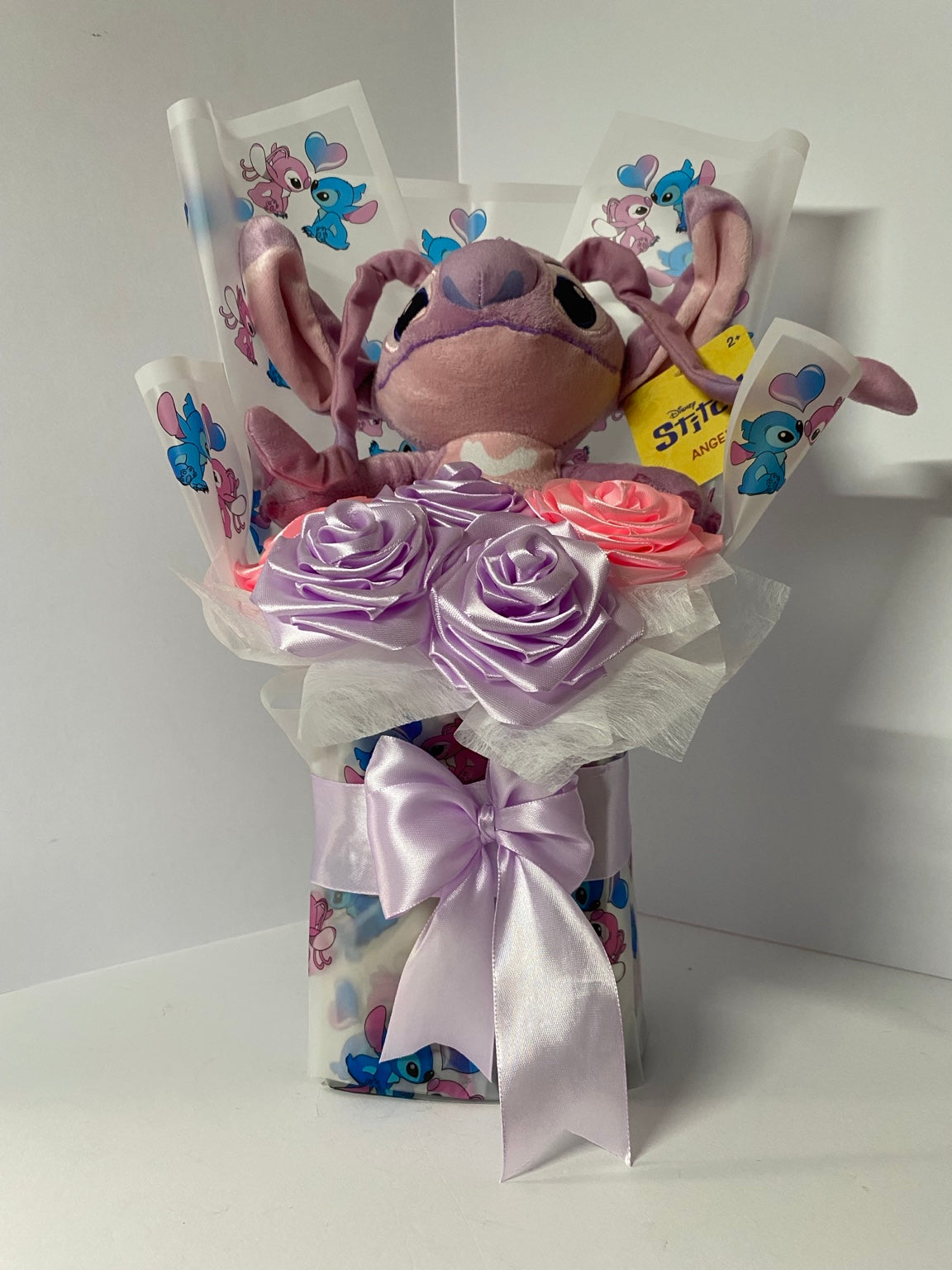 Close view of handmade satin roses and plush centerpiece