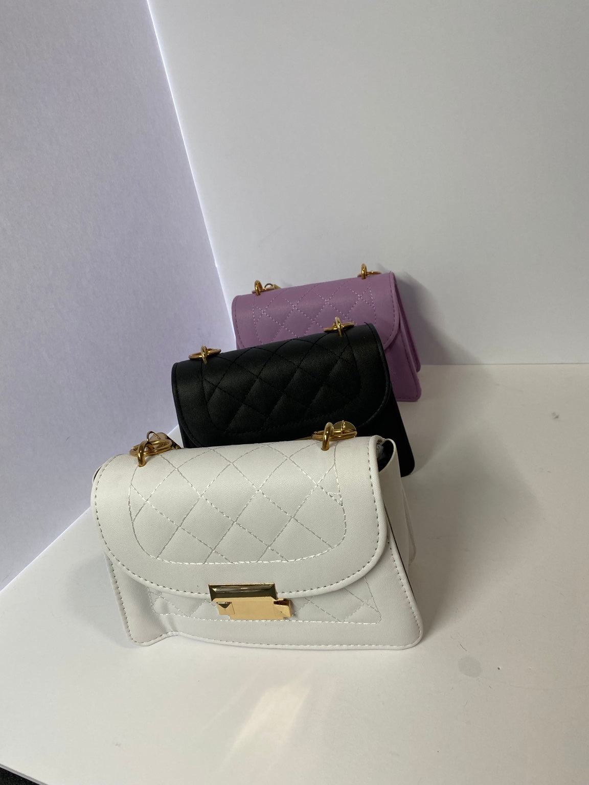 White, black, and lavender mini quilted handbags