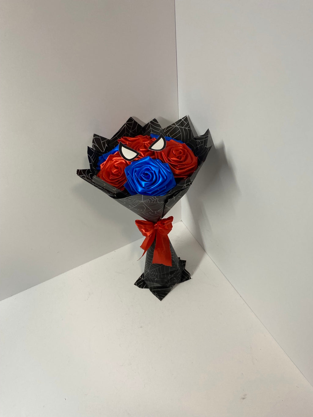 Front view of mini satin rose bouquet with black wrap