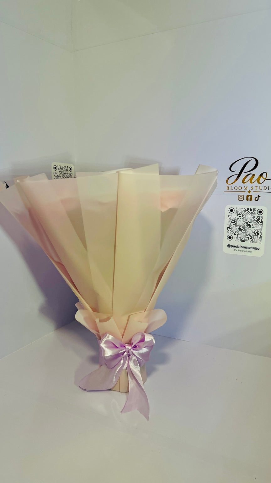 Back view of pink wrapped everlasting satin rose bouquet