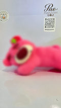 Pink strawberry bear plush with strong selective blur, view 1