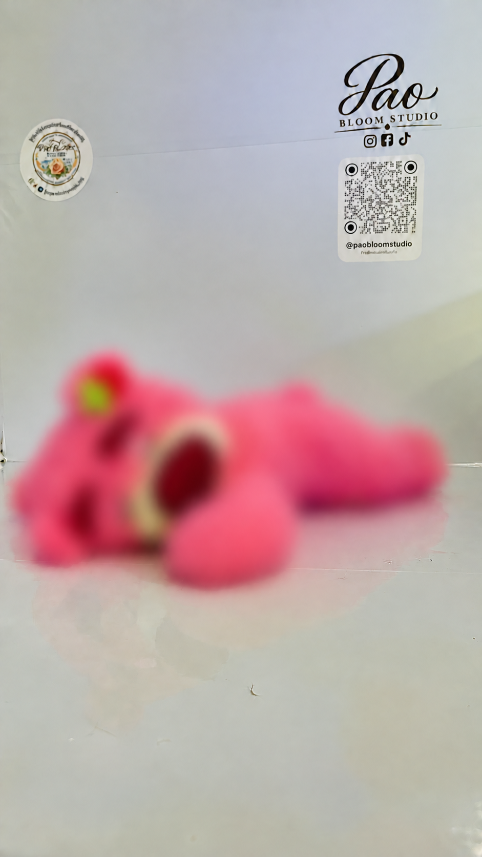 Pink strawberry bear plush with strong selective blur, view 2
