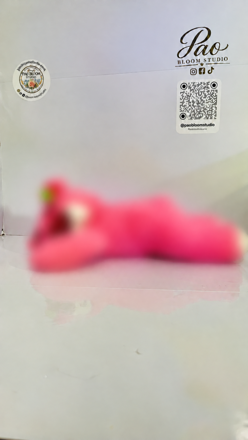 Pink strawberry bear plush with strong selective blur, view 3