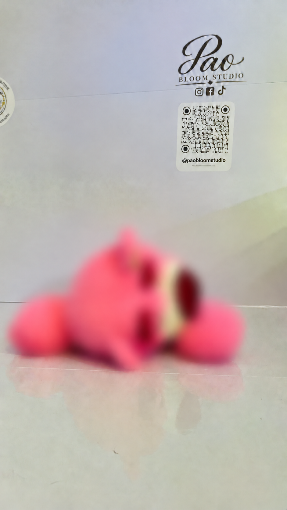 Pink strawberry bear plush with strong selective blur, view 4
