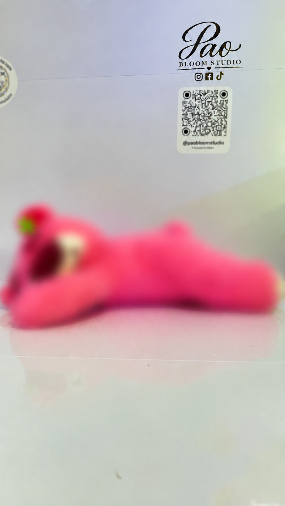 Pink strawberry bear plush with strong selective blur, view 5