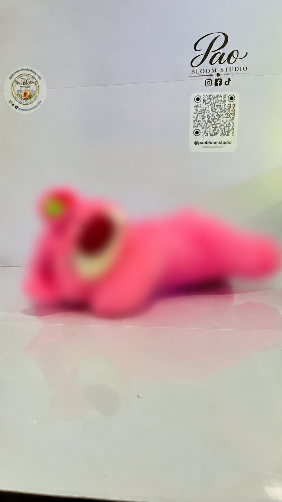 Pink strawberry bear plush with strong selective blur, view 6