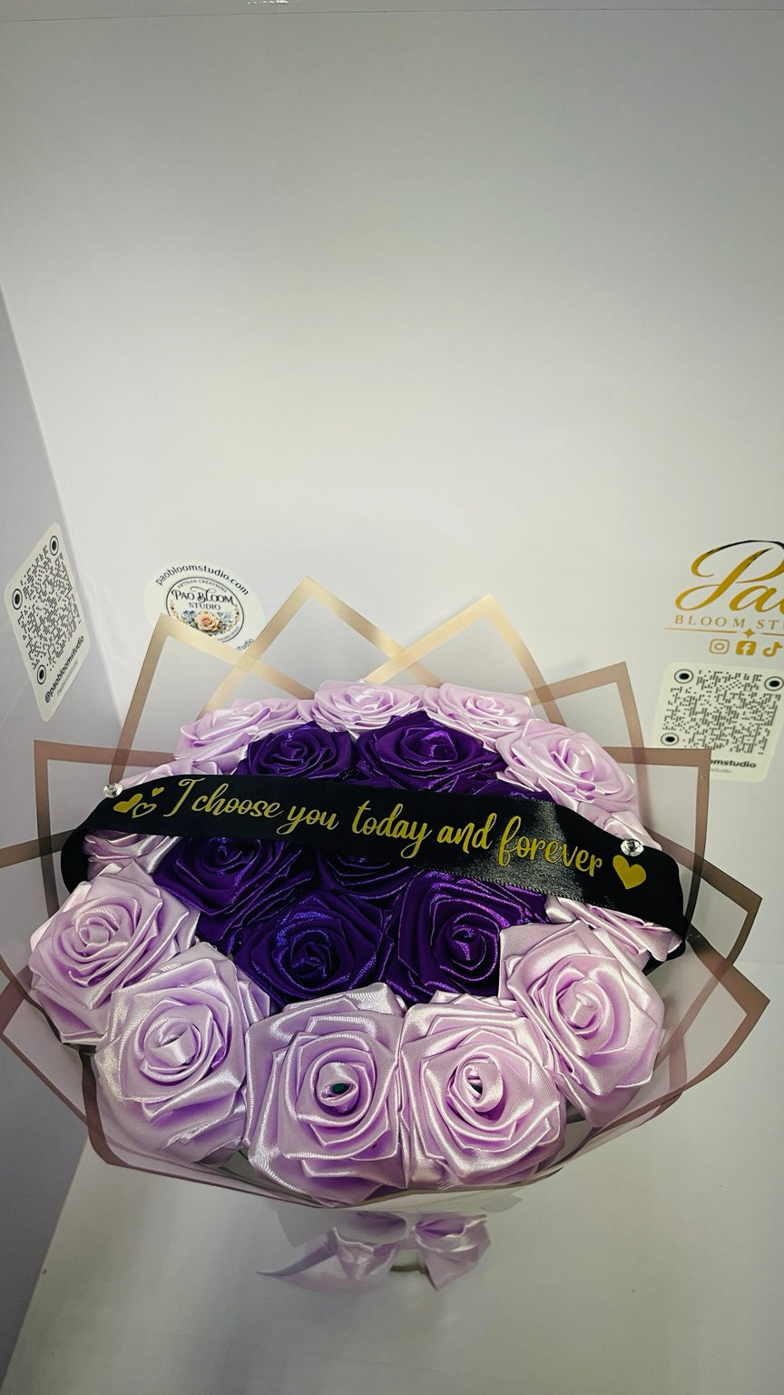 Purple and lavender satin rose bouquet with personalized black ribbon