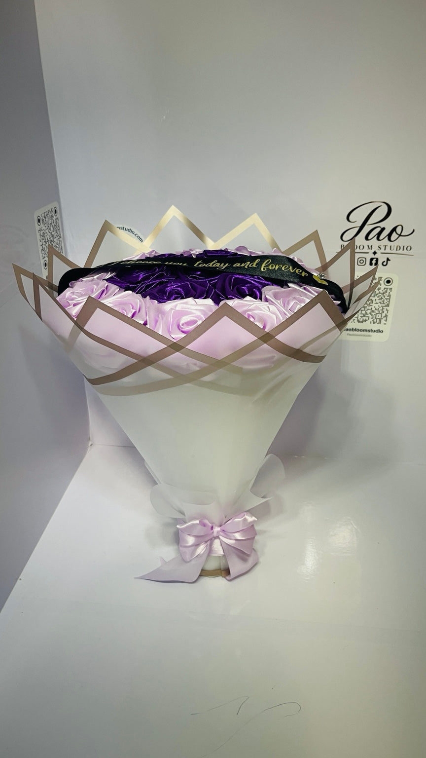 Side view of purple lavender satin rose bouquet and geometric wrapping