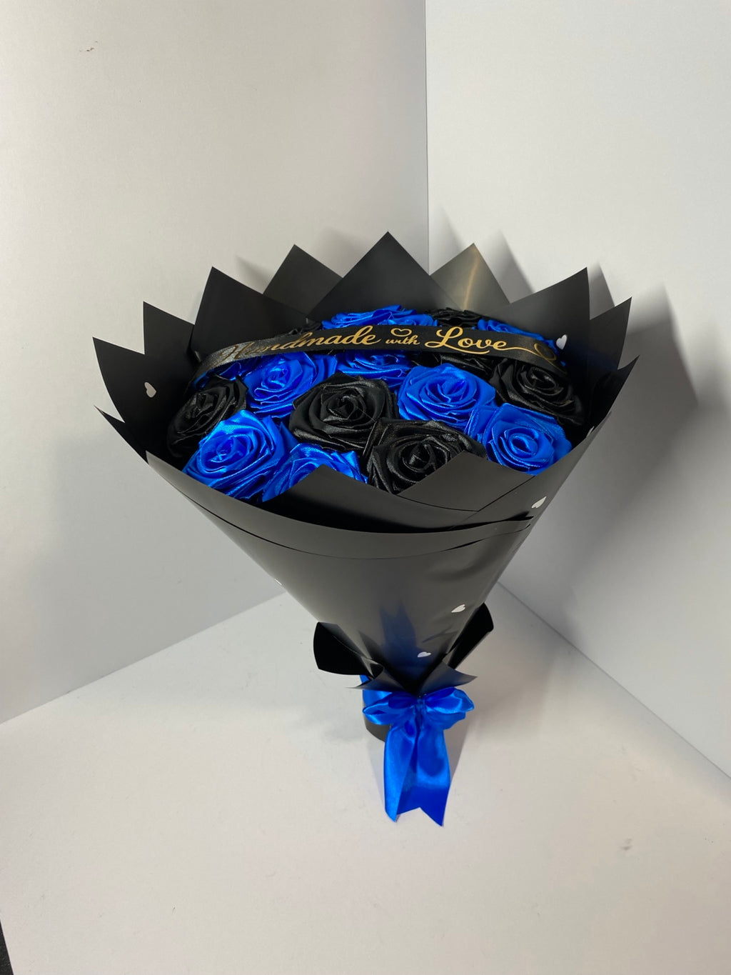 Royal blue and black handmade satin rose bouquet, angled view