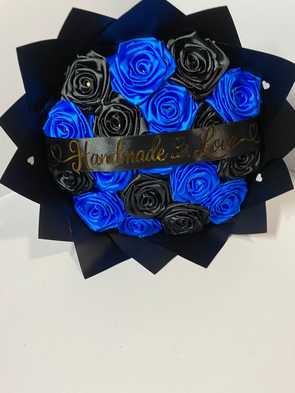 Royal blue and black satin ribbon roses, overhead view